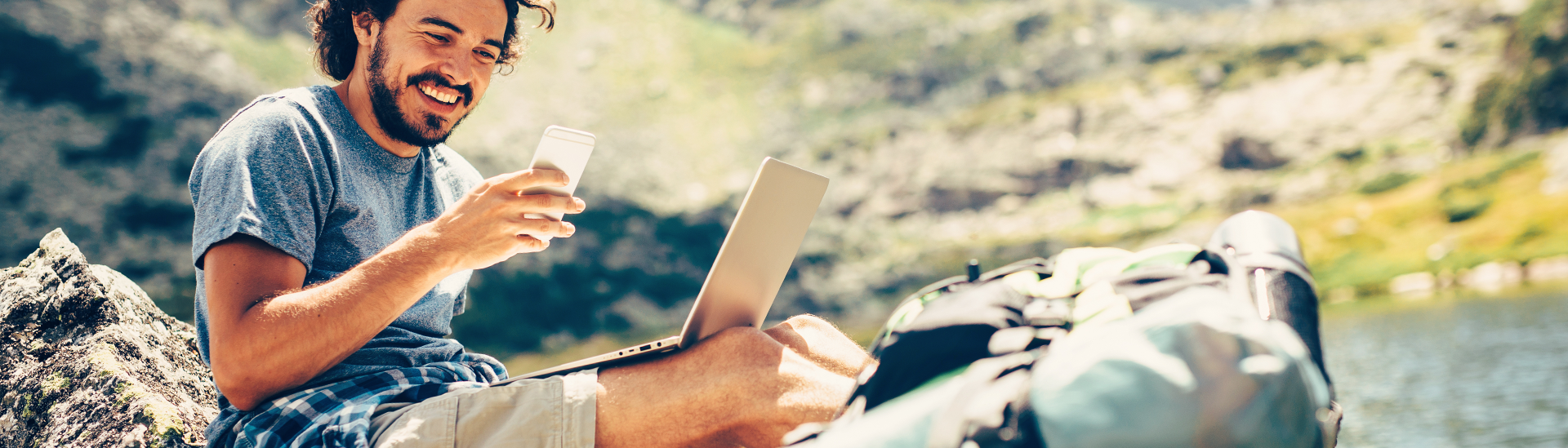 camping man with phone and labtop computer